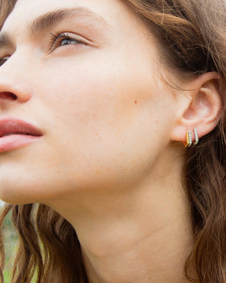 Two-Tone Infinity Huggie Earrings with White Sapphires thumbnail
